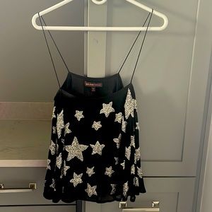 Black tank top with silver sequin stars.